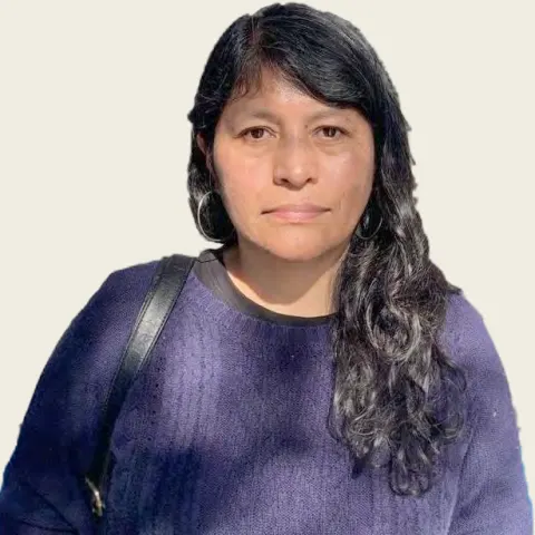 Portrait of Patricia Loredo, with long dark hair and a blue sweater.